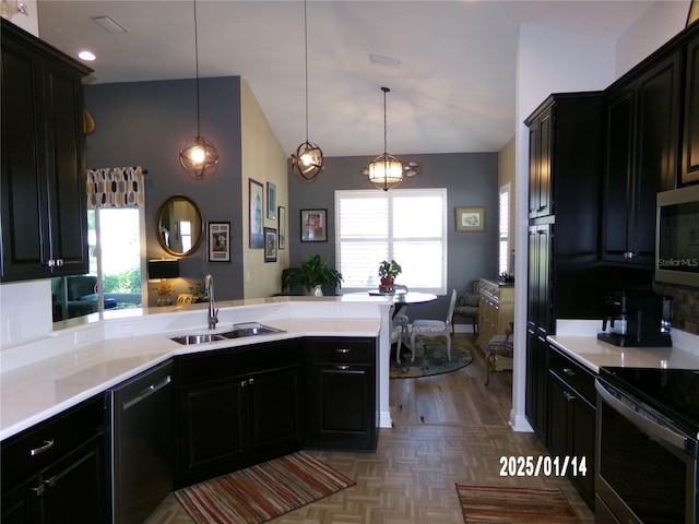 kitchen featuring vaulted ceiling, sink, stainless steel appliances, kitchen peninsula, and hanging light fixtures