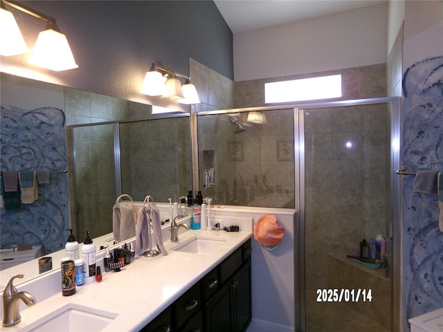 bathroom with vanity and a shower with door