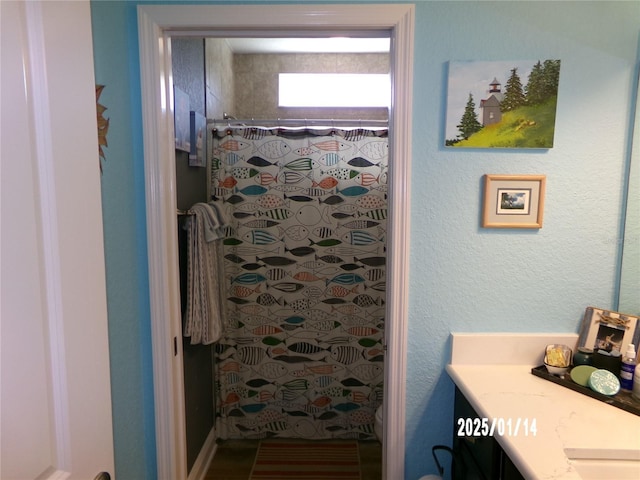 bathroom featuring vanity and a shower with curtain