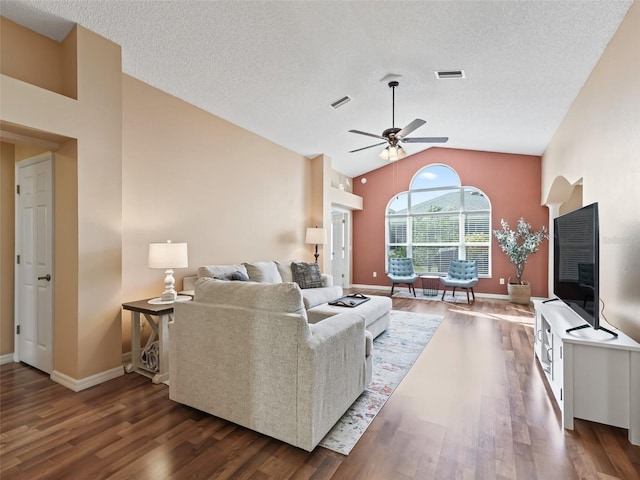 living room featuring dark hardwood / wood-style flooring, a textured ceiling, high vaulted ceiling, and ceiling fan