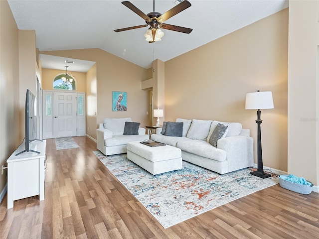 living room featuring ceiling fan, lofted ceiling, and hardwood / wood-style floors