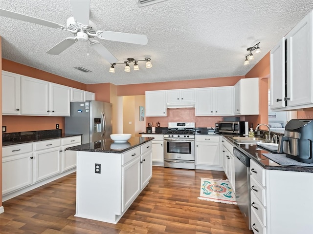 kitchen featuring stainless steel appliances, white cabinetry, and sink