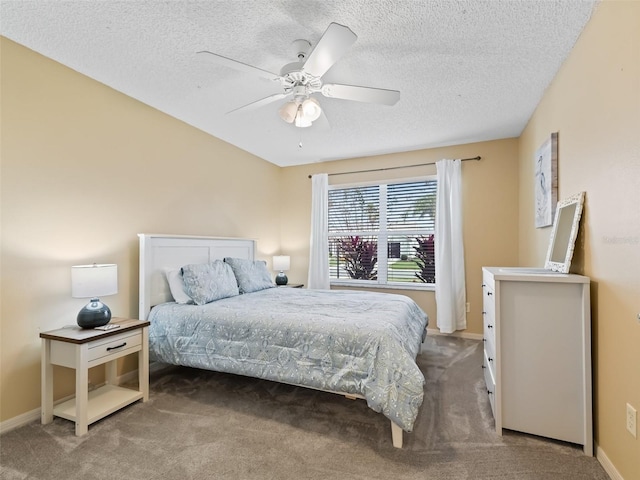 carpeted bedroom with ceiling fan and a textured ceiling