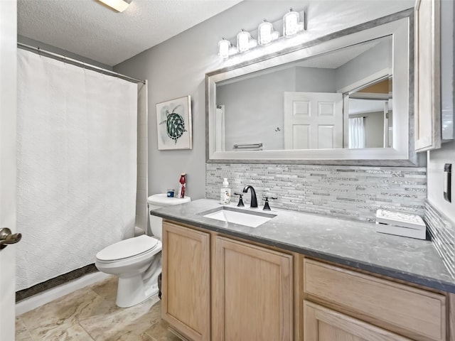 bathroom featuring vanity, tasteful backsplash, toilet, and a textured ceiling