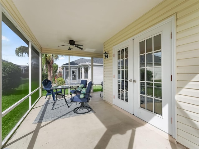 sunroom / solarium featuring ceiling fan and french doors