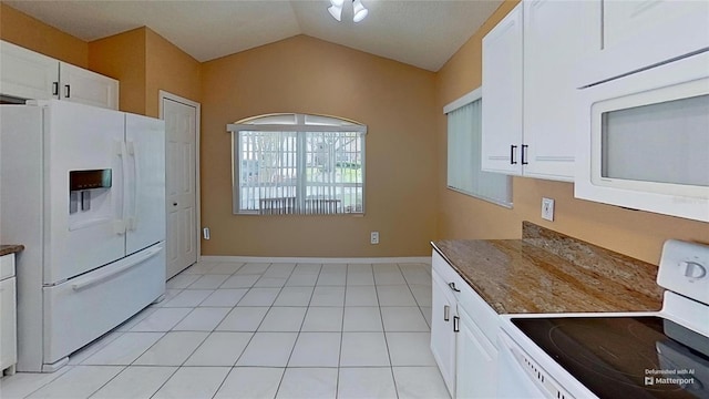 kitchen with vaulted ceiling, light tile patterned floors, white cabinets, and white appliances