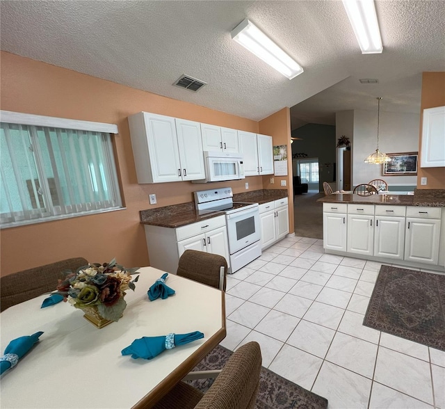 kitchen with lofted ceiling, white cabinetry, light tile patterned floors, pendant lighting, and white appliances