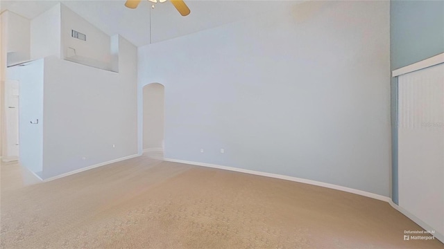 unfurnished bedroom with light carpet, high vaulted ceiling, a closet, and ceiling fan