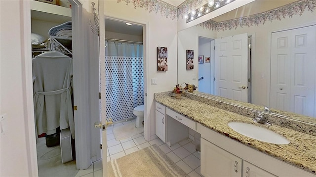 bathroom featuring a shower with curtain, vanity, toilet, and tile patterned flooring