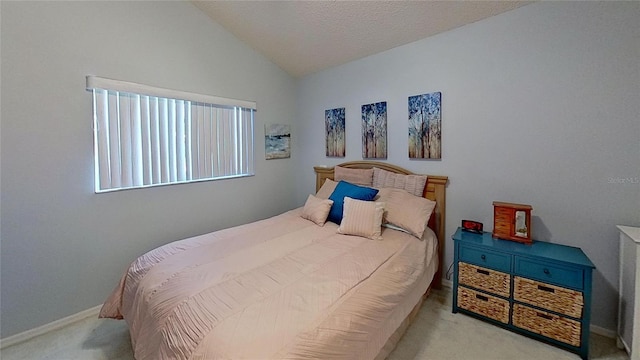 bedroom with vaulted ceiling and light colored carpet