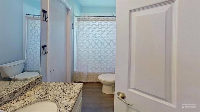 bathroom featuring vanity, hardwood / wood-style floors, and toilet