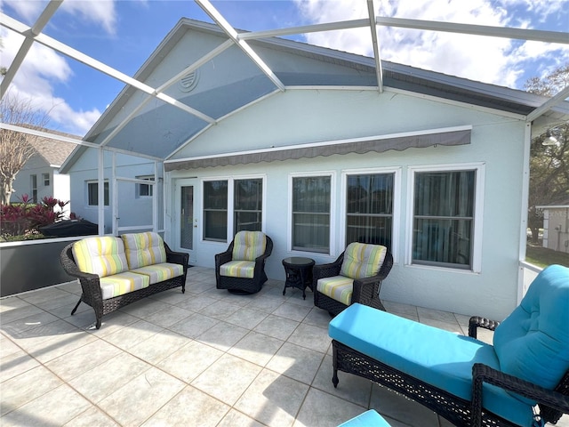 rear view of house with outdoor lounge area, glass enclosure, and a patio area