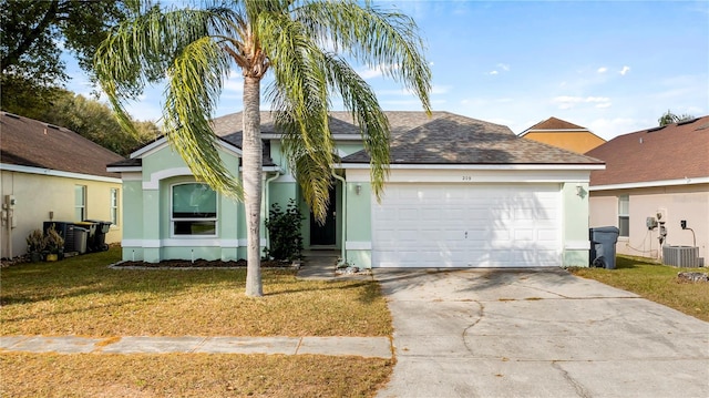 view of front of property with a garage, a front lawn, and central air condition unit