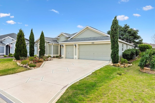 ranch-style house featuring a garage, a shingled roof, concrete driveway, stucco siding, and a front lawn