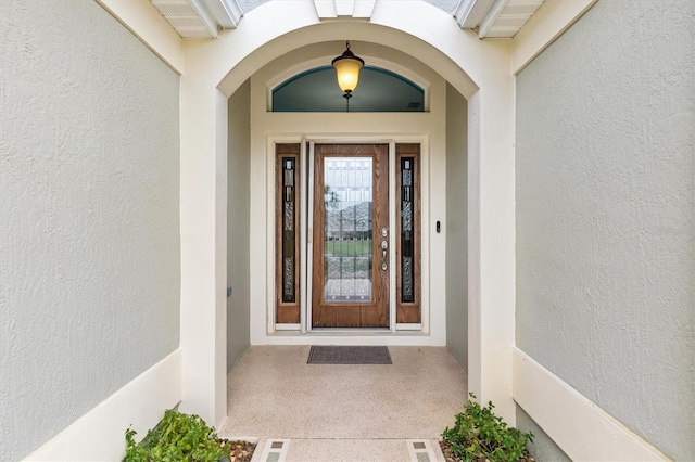 view of exterior entry with stucco siding