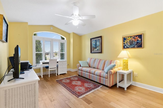 office space featuring lofted ceiling, ceiling fan, light wood-type flooring, and baseboards