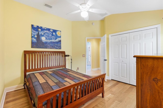 bedroom with light wood-type flooring, baseboards, visible vents, and lofted ceiling