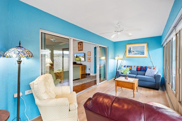 living area featuring ceiling fan and wood finished floors