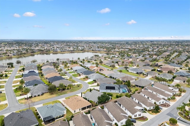 birds eye view of property featuring a water view and a residential view