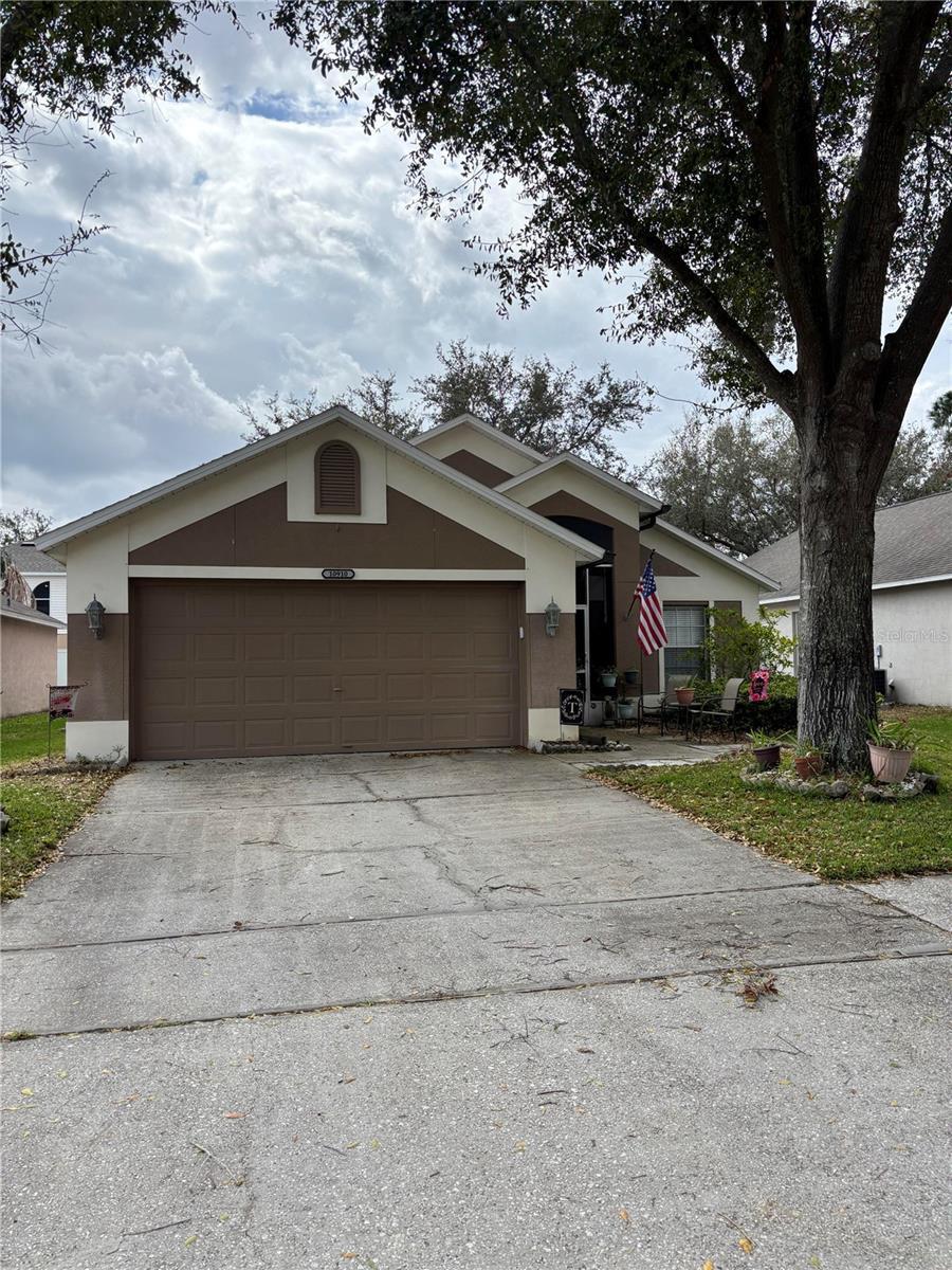 view of front of home featuring an attached garage, driveway, and stucco siding