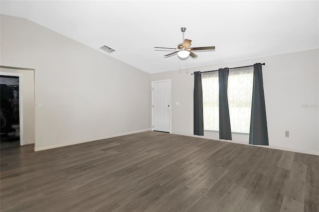 spare room featuring dark wood-type flooring, ceiling fan, and vaulted ceiling