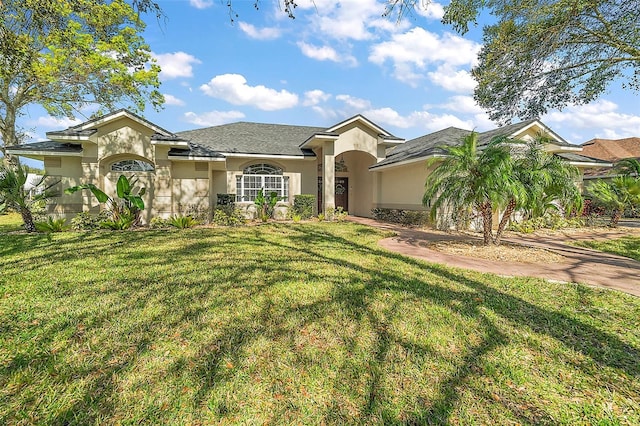 view of front facade featuring a front yard and stucco siding