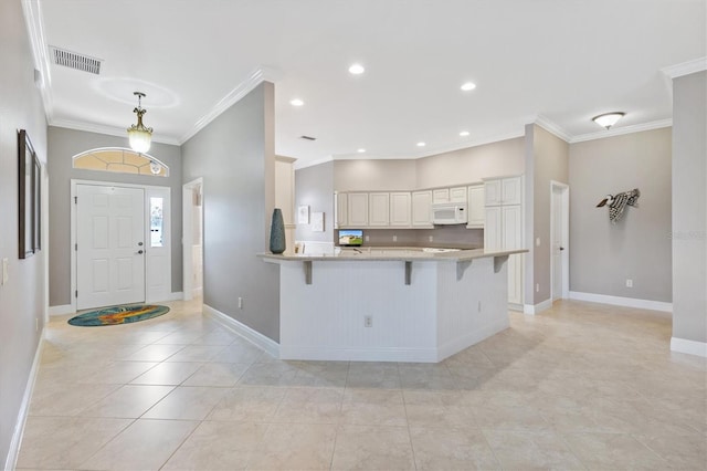 interior space with baseboards, ornamental molding, visible vents, and light tile patterned floors