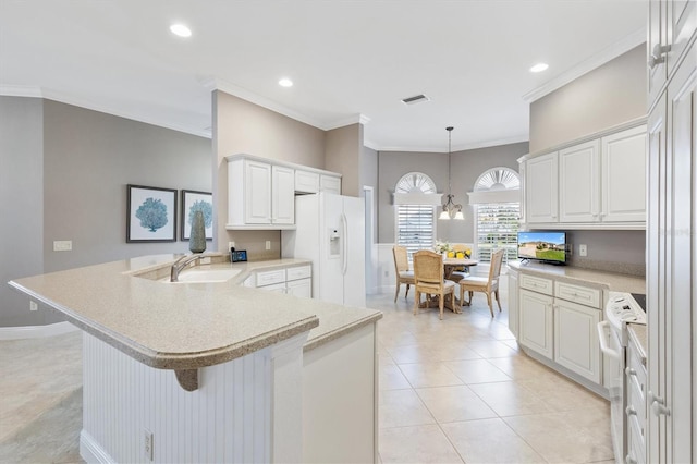 kitchen featuring a breakfast bar area, light countertops, decorative light fixtures, white cabinets, and white appliances