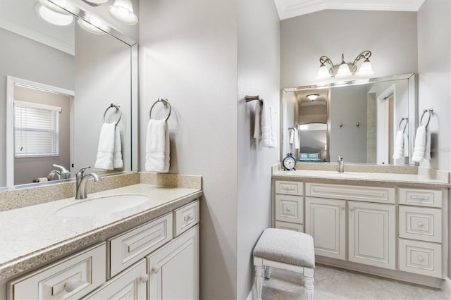 bathroom featuring two vanities, ornamental molding, and a sink