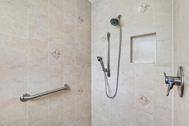 full bath with a tile shower