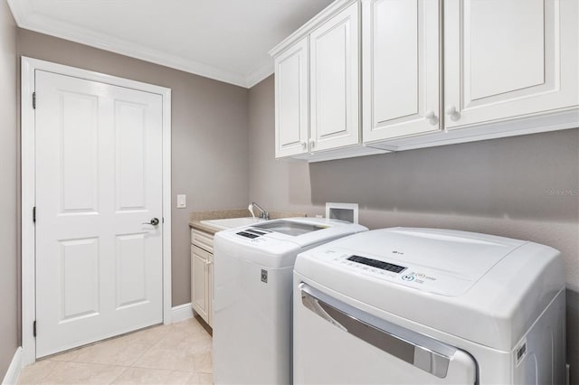 laundry room with cabinet space, light tile patterned floors, ornamental molding, a sink, and washing machine and clothes dryer