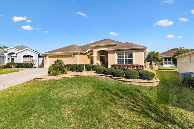 view of front of home with cooling unit, a front yard, driveway, stucco siding, and a garage