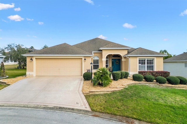 ranch-style home featuring stucco siding, a garage, concrete driveway, and a front yard