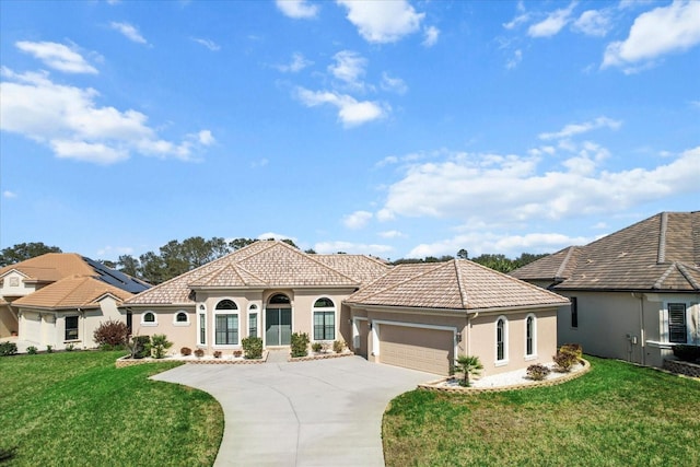 mediterranean / spanish-style house featuring a garage and a front yard