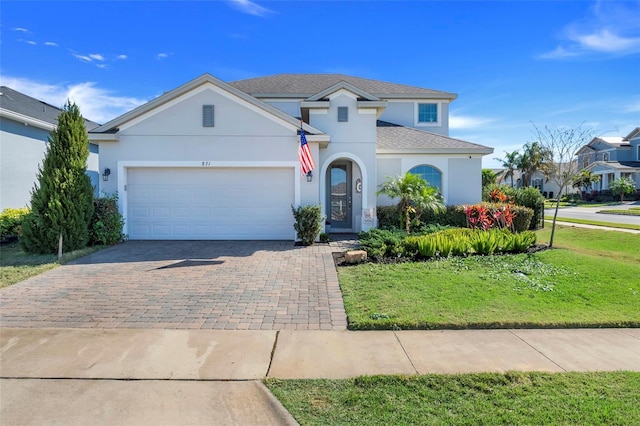 view of front facade with a garage and a front lawn