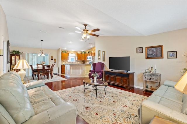 living room featuring a ceiling fan, dark wood finished floors, visible vents, and vaulted ceiling