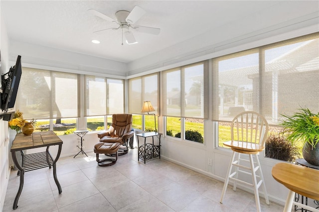 sunroom with a ceiling fan and a healthy amount of sunlight