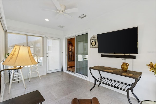 living room featuring visible vents and ceiling fan