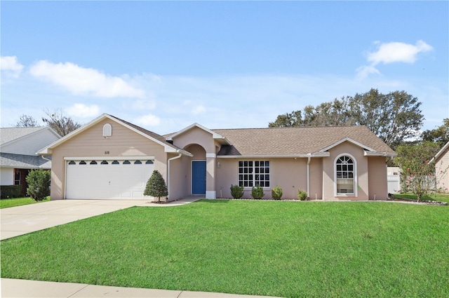 ranch-style home with stucco siding, a front lawn, an attached garage, and concrete driveway