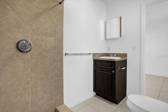 bathroom featuring vanity, tile patterned floors, and toilet