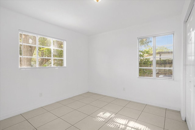 tiled spare room with a wealth of natural light