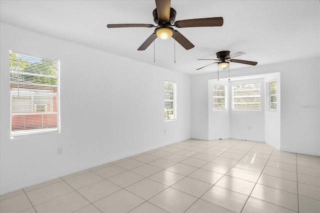 unfurnished room with light tile patterned flooring and a healthy amount of sunlight