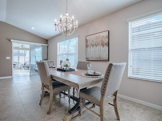 dining space featuring light tile patterned floors, a notable chandelier, vaulted ceiling, and a textured ceiling