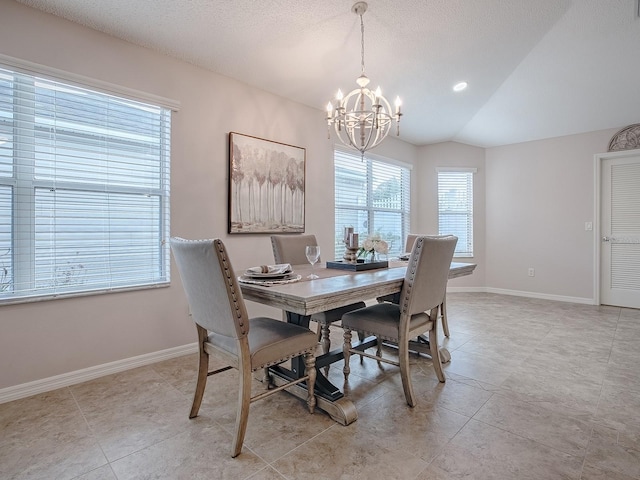 tiled dining room featuring an inviting chandelier, lofted ceiling, and a textured ceiling