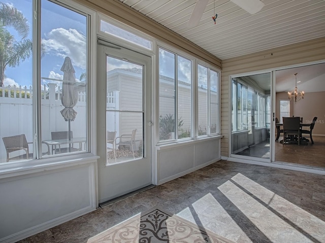 unfurnished sunroom with a notable chandelier