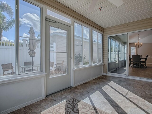 591 Statesburg St, The Villages, FL 32162 - unfurnished sunroom featuring baseboards and an inviting chandelier