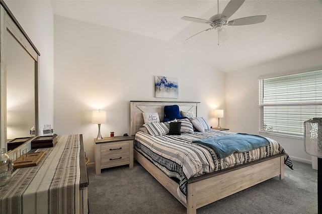 bedroom with dark carpet, vaulted ceiling, and ceiling fan