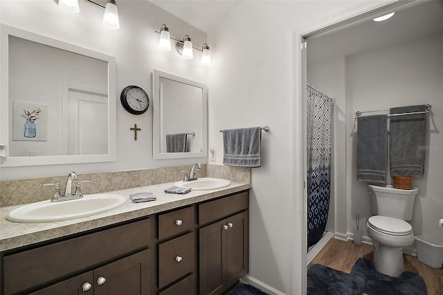 bathroom with vanity, a shower with curtain, toilet, and hardwood / wood-style floors