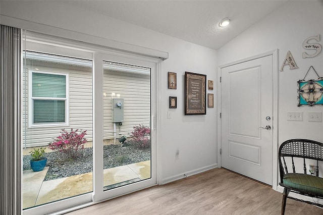 entryway featuring light wood-type flooring and lofted ceiling