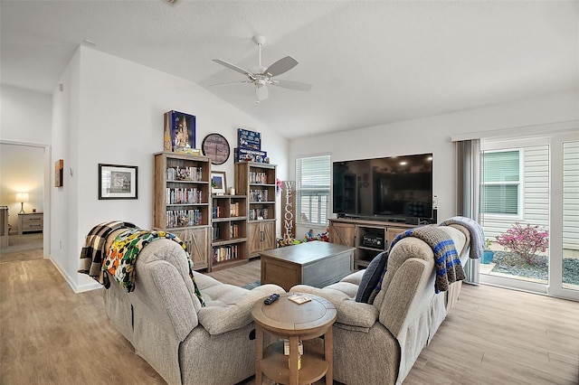 living room with light wood-type flooring, lofted ceiling, and ceiling fan